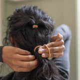 On Hair Image of KOOSHOO plastic-free round hair ties mondo 8 pack golden fibres	#color_golden-fibres
